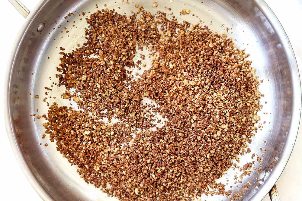 showing how to make chicken cordon bleu casserole recipe by toasting panko in a stainless steal skillet