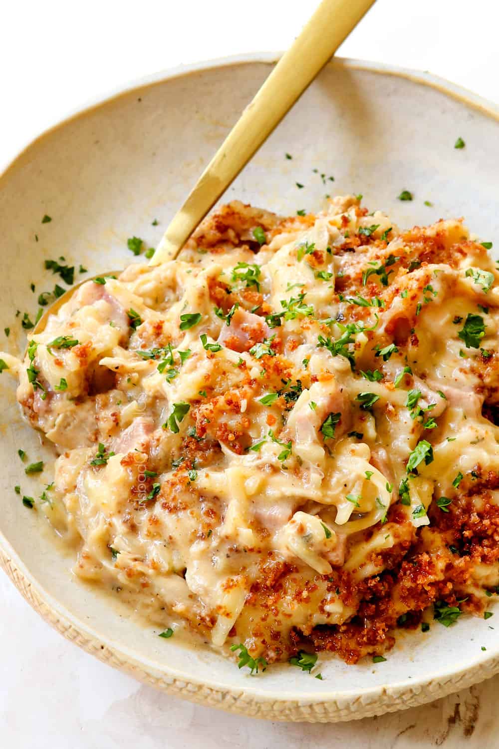 a plate of chicken cordon bleu casserole (ham casserole) on a plate with panko and parsley