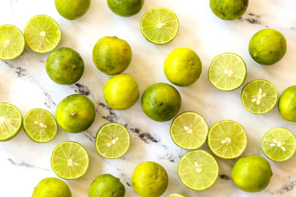 key limes lined on a marble counter showing what they look like for key lime cheesecake