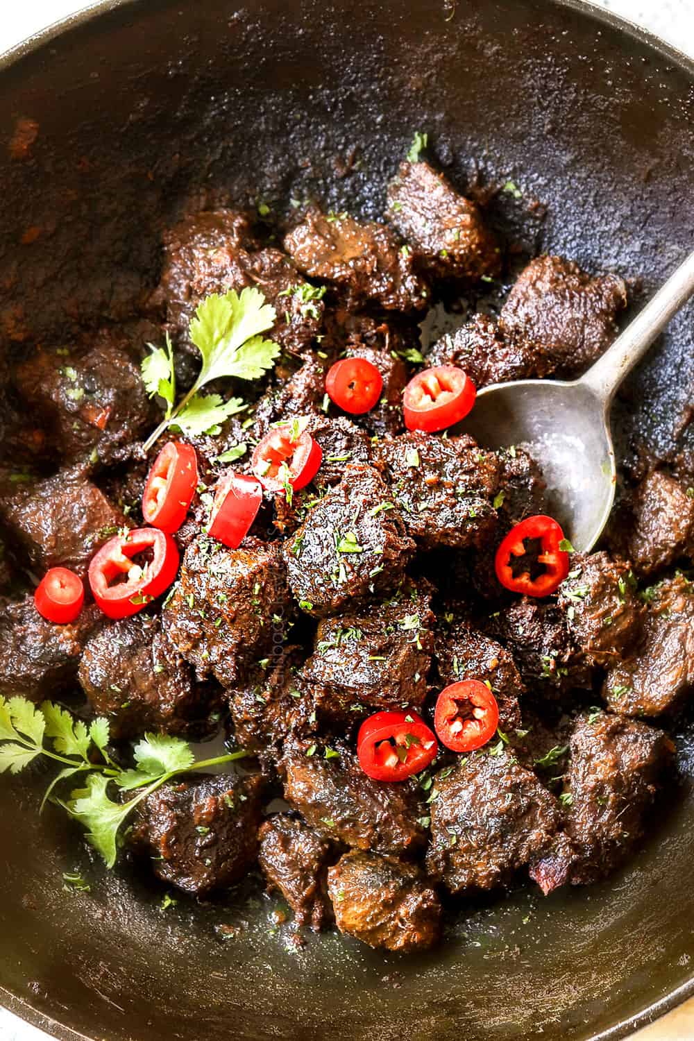 top view of beef rendang recipe in a black Dutch oven