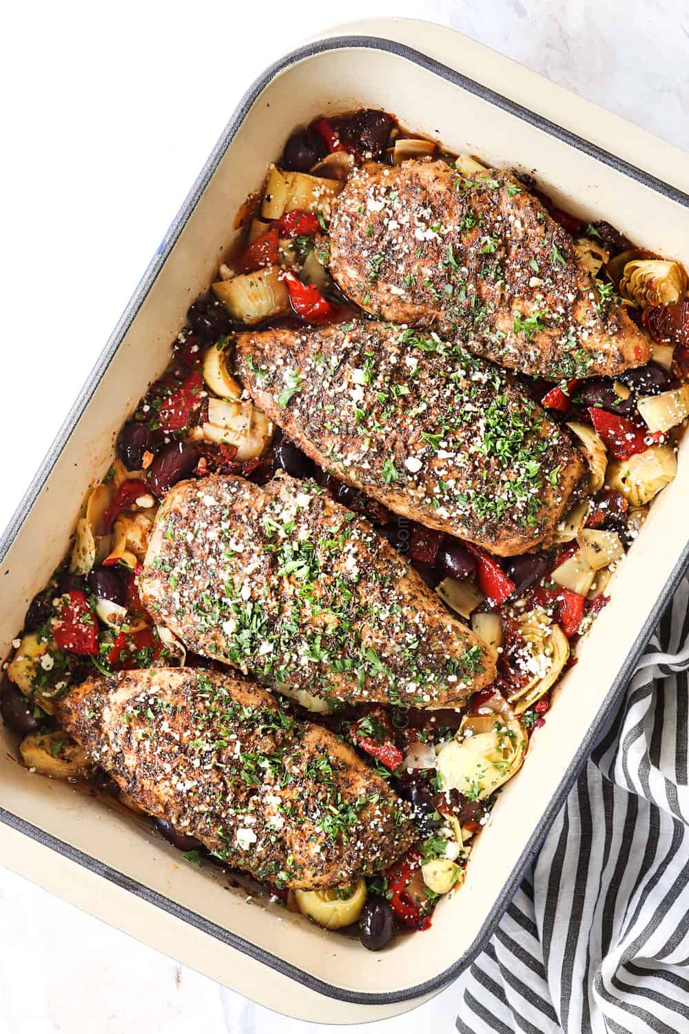 top view of Greek chicken garnished with feta and parsley