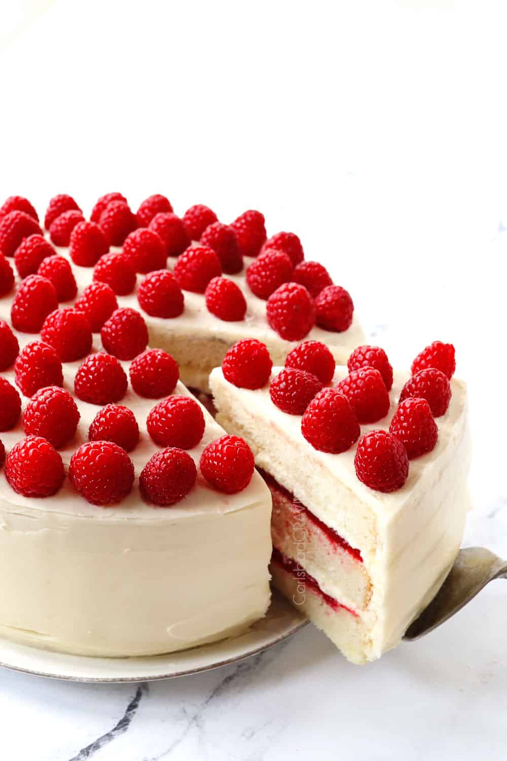 pulling out a piece of white chocolate raspberry cake