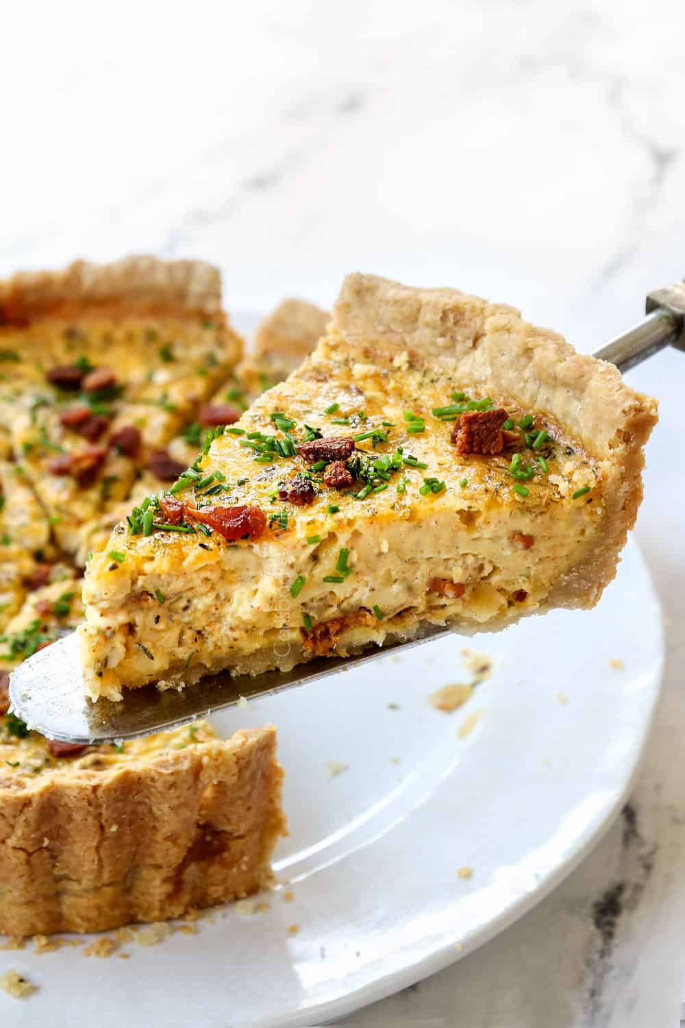 holding Quiche Lorraine on a spatula