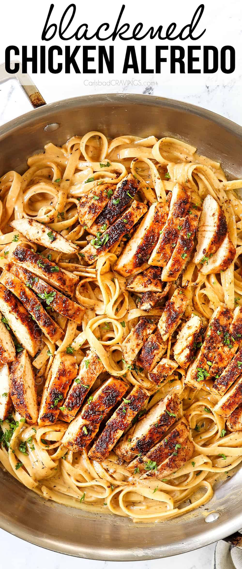 top view of Blackened Chicken Alfredo in a stainless steel skillet