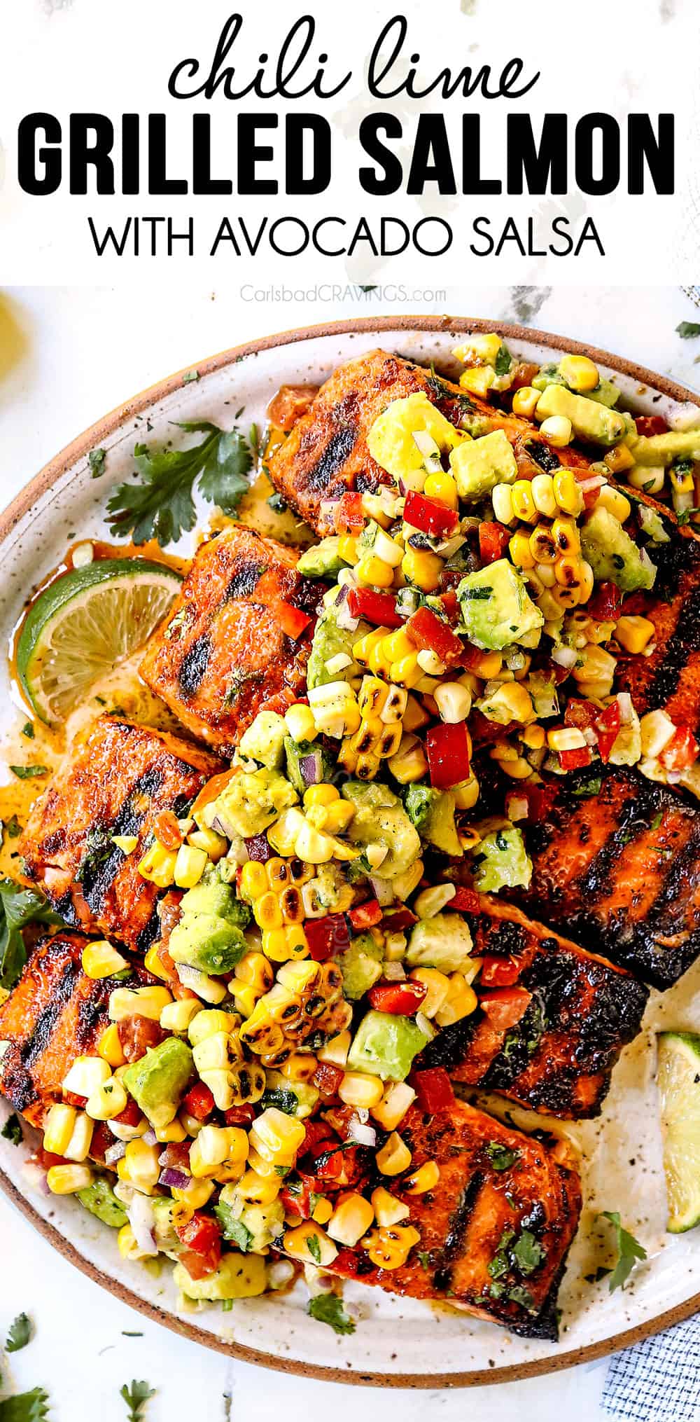 top view of grilled salmon on a plate with avocado corn salsa