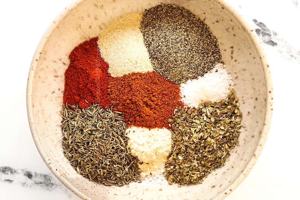 showing how to grill steak by whisking the steak rub together in bowl