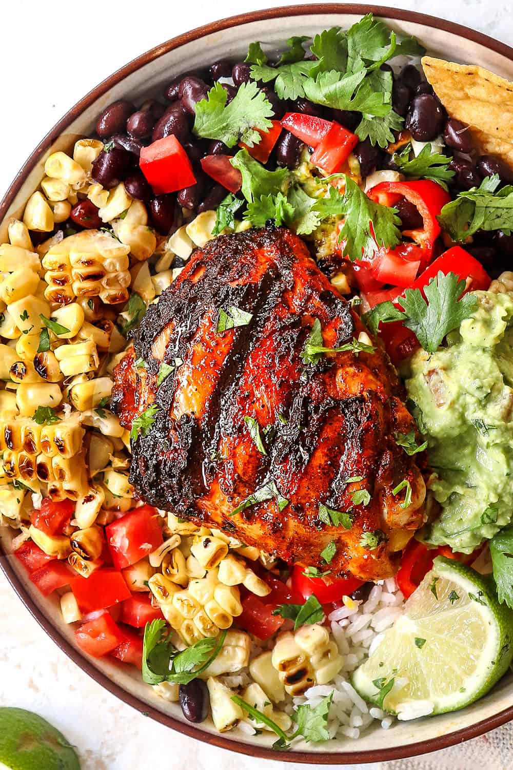 top view of pollo asado with rice, beans and corn showing what to serve with pollo asado