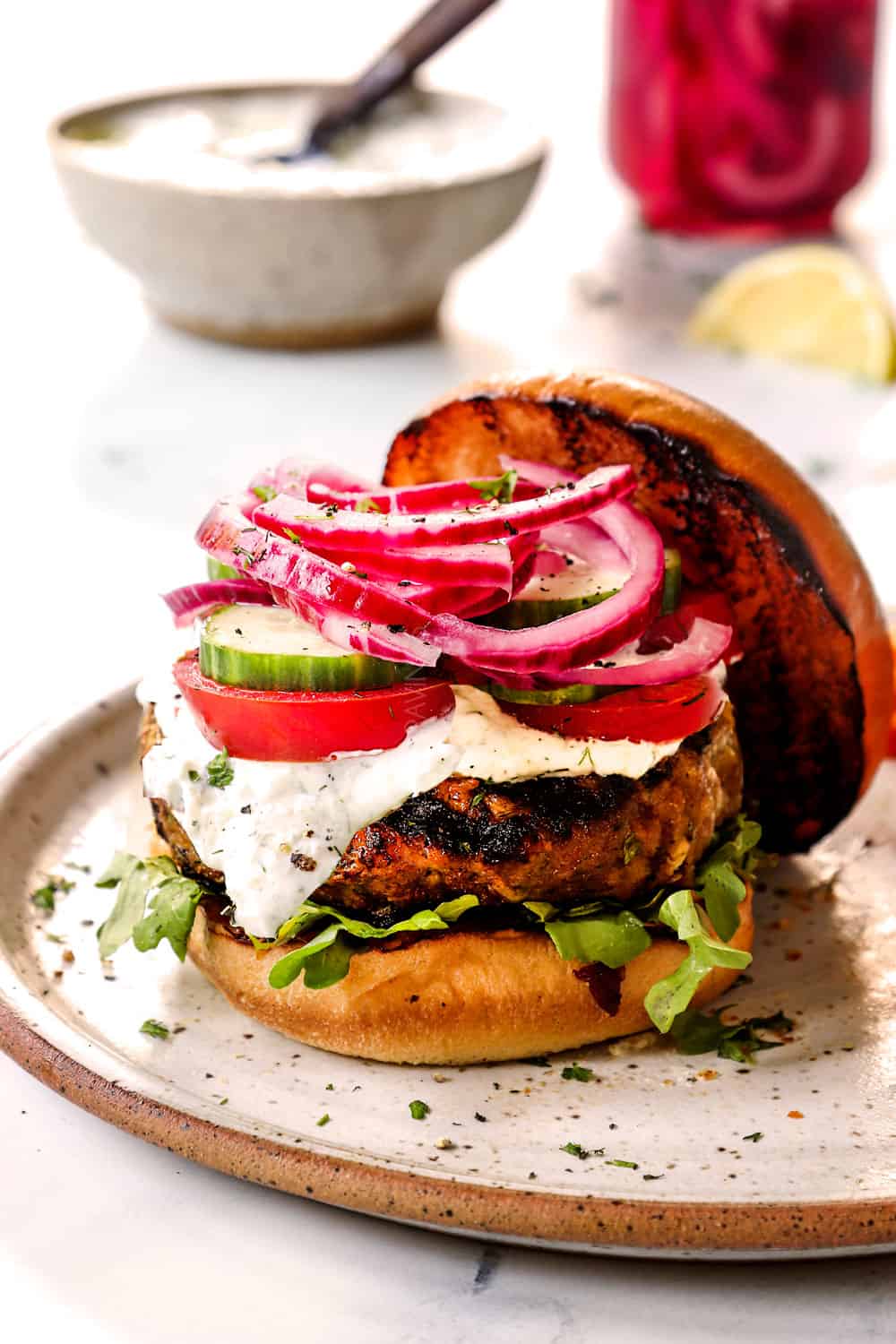 up close of Greek burger with lamb and tzatziki