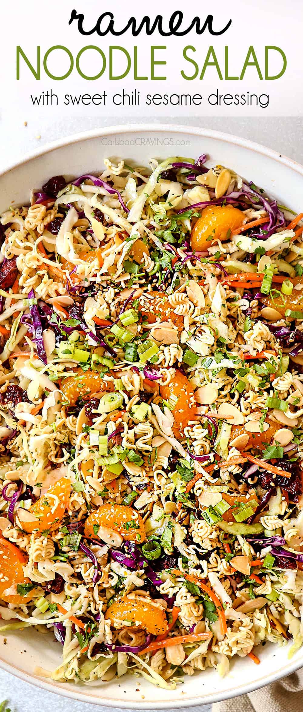 top view showing how to make Asian Ramen Noodle Salad by tossing the ingredients together with the dressing in a white bowl