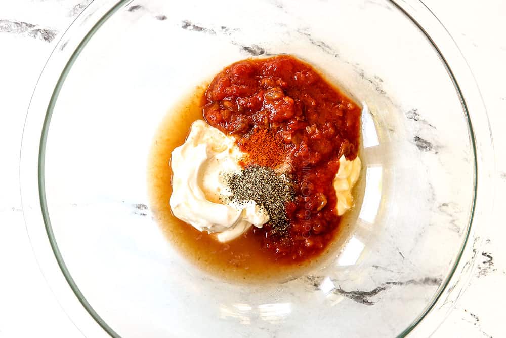 showing how to make chicken fajita salad by whisking together dressing ingredients: salsa, sour cream, mayonnaise and spices, in a glass bowl