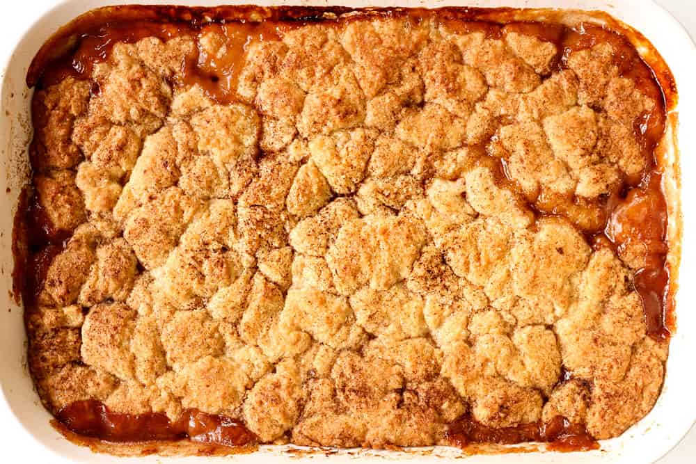 showing how to make peach cobbler by baking homemade peach cobbler until the topping is golden