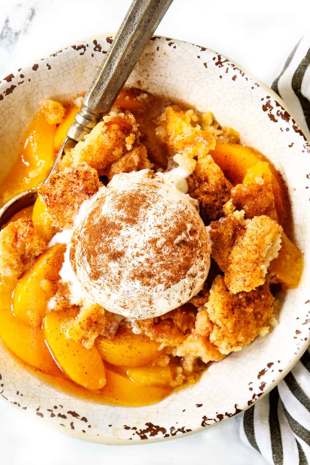 top view of peach cobbler recipe with vanilla ice cream