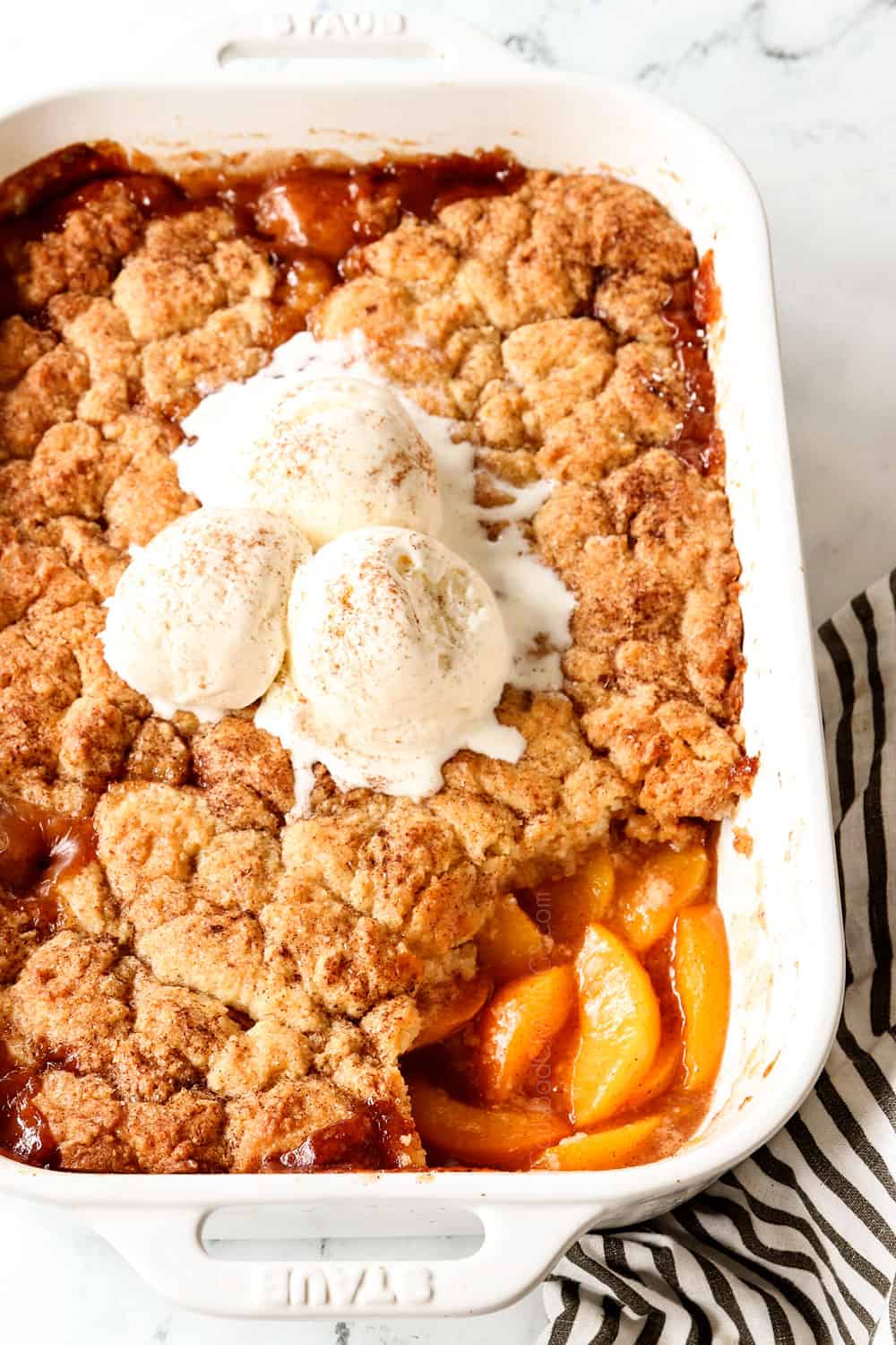 a pan of peach cobbler recipe with fresh peaches