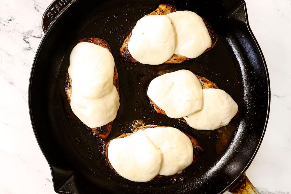 showing how to make chicken Caprese recipe by adding mozzarella slices to the chicken and letting them melt
