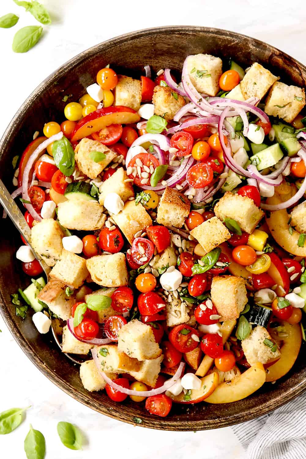 top view of Panzanella in a wood bowl with tomatoes, bread and onions