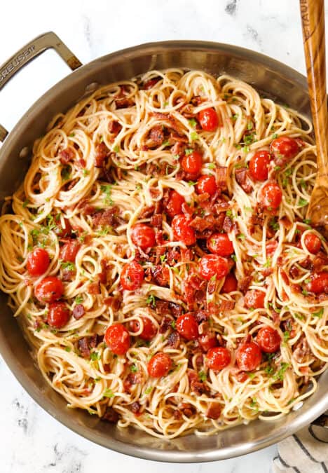 top view of bacon pasta with garlic and Parmesan in a skillet