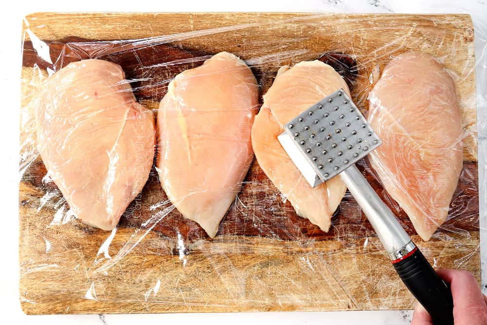 showing how to make blackened chicken recipe by pounding chicken to an even thickness