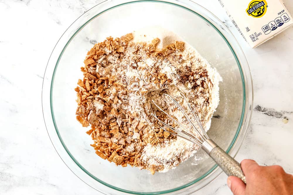 showing how to make cereal pancakes by whisking Cinnamon Toast Crunch Cereal, flour, sugar and baking powder together in a glass bowl