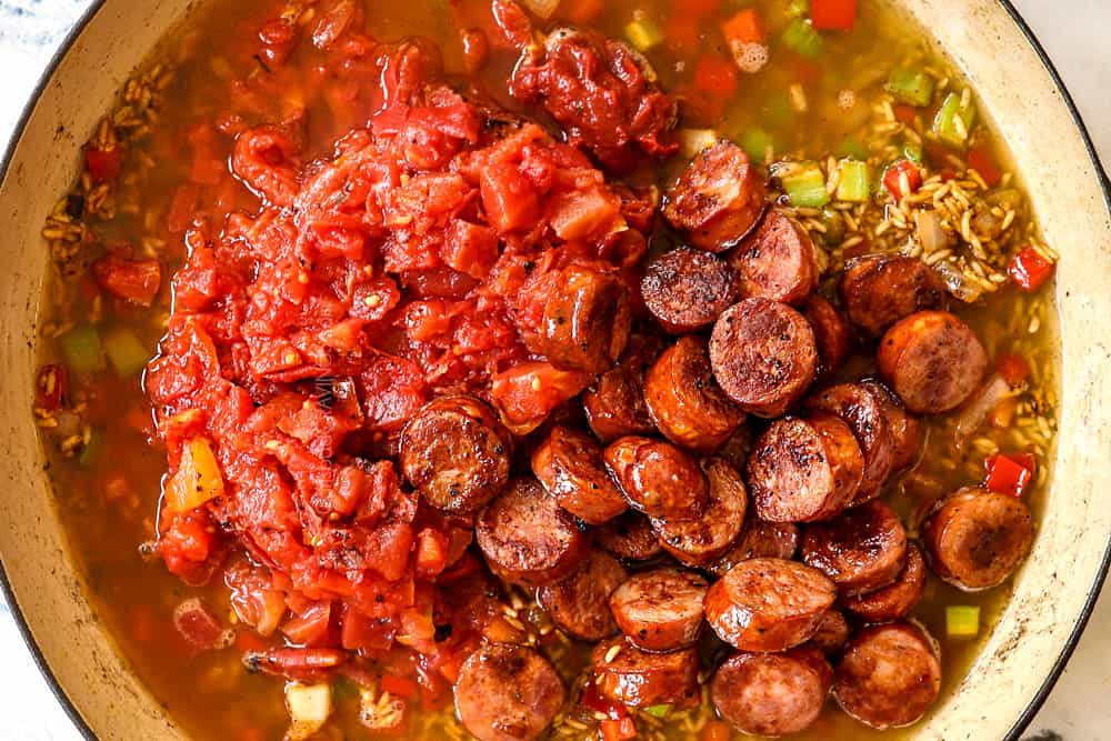 showing how to make Cajun shrimp recipe by adding diced tomatoes and chicken broth to the pot