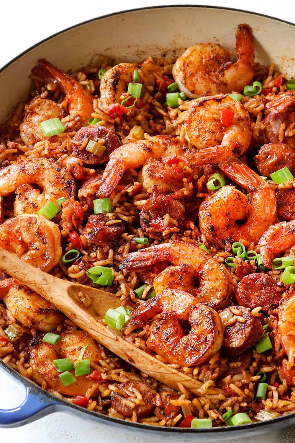 showing how to make Cajun shrimp with rice by combing shrimp with rice in a pot