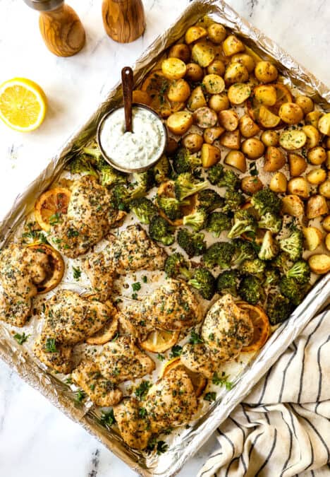 showing how to make lemon garlic chicken recipe by baking chicken thighs until golden