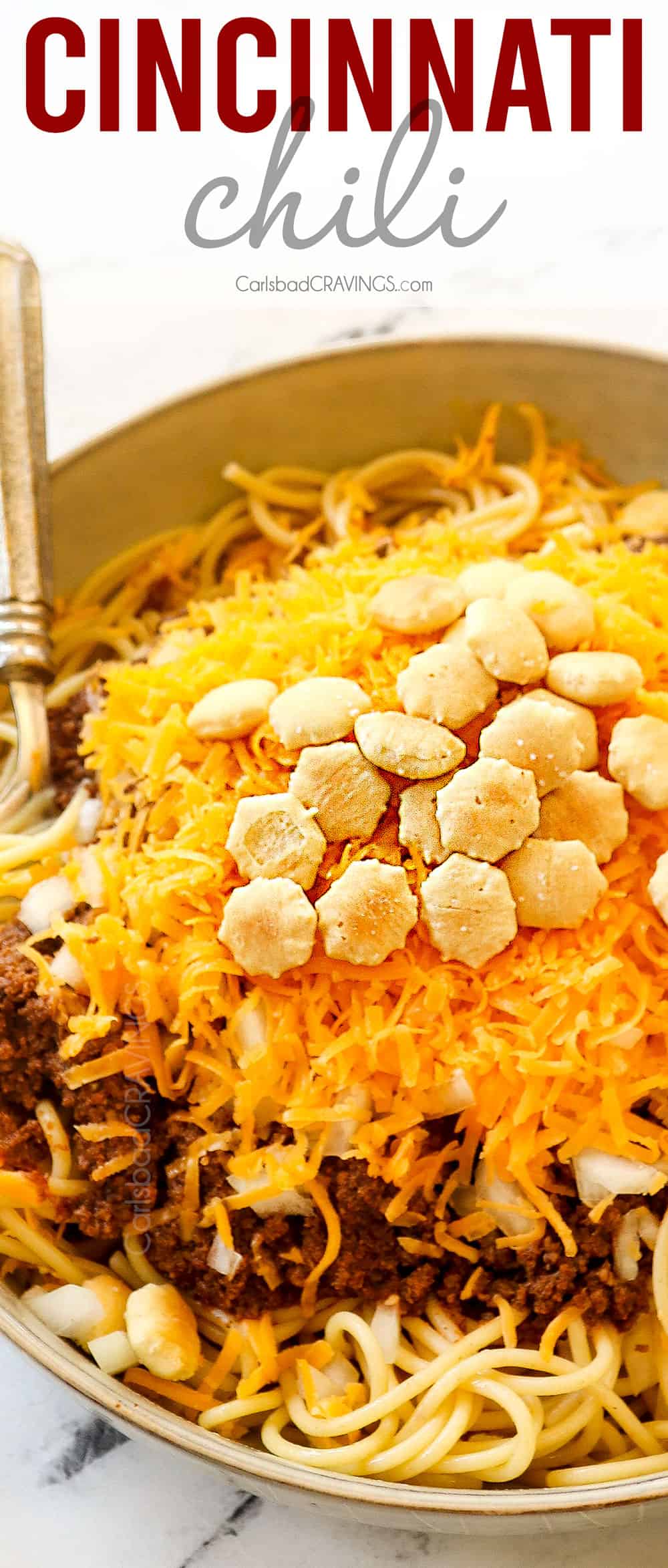 up close of skyline chili Cincinnati in a bowl with cheese, onions and oyster crackers