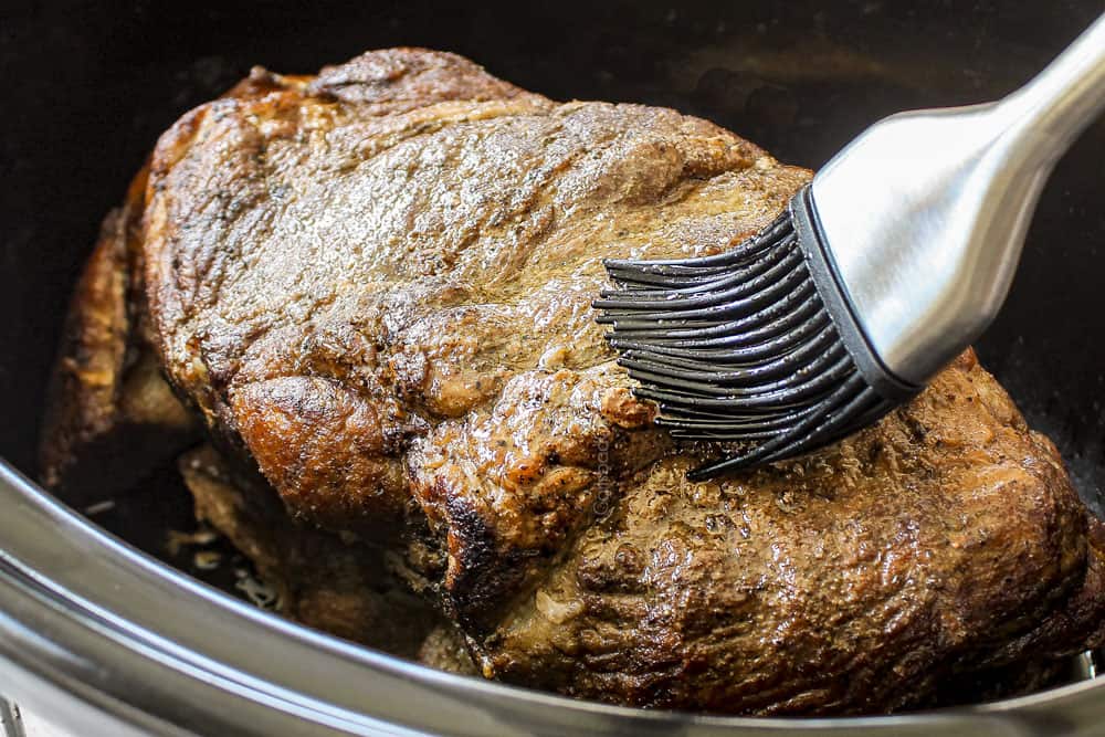 showing how to make Kalua Pork (Kalua Pig) recipe by brushing the pork with liquid smoke