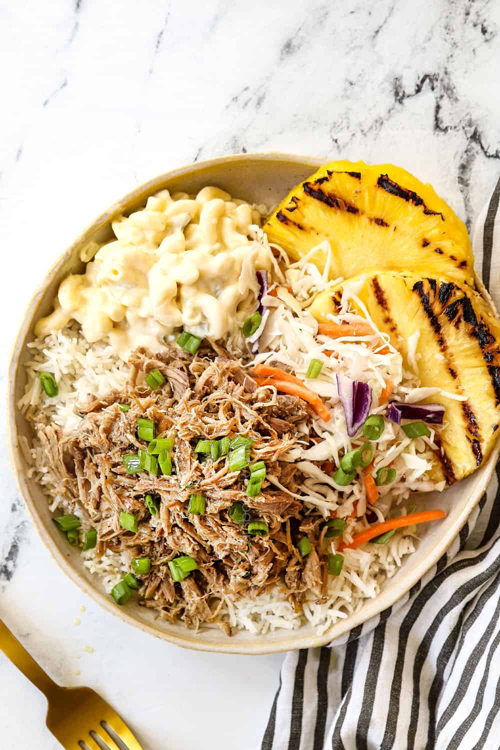 top view of a plate of Kalua Pork recipe with rice, pineapple and macaroni salad