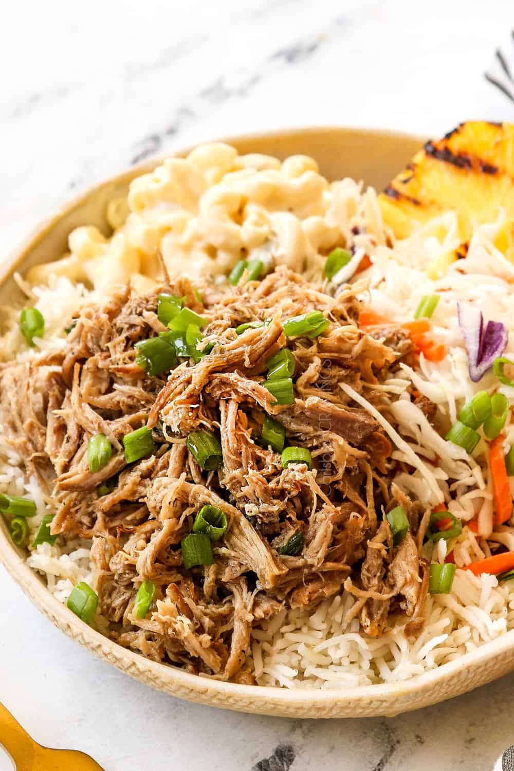 a plate of Kalua Pork recipe with rice, pineapple and macaroni salad
