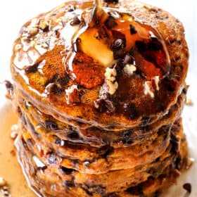 pouring syrup of a stack of pumpkin spice pancakes