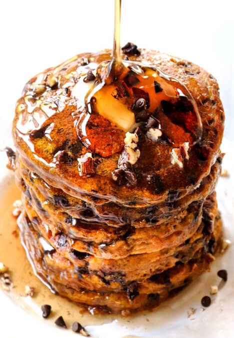 pouring syrup of a stack of pumpkin spice pancakes