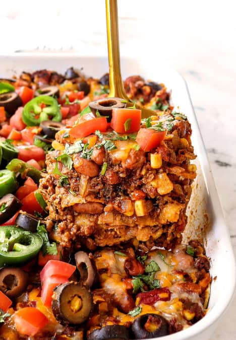 up close of a slice of beef enchilada casserole showing the different layers