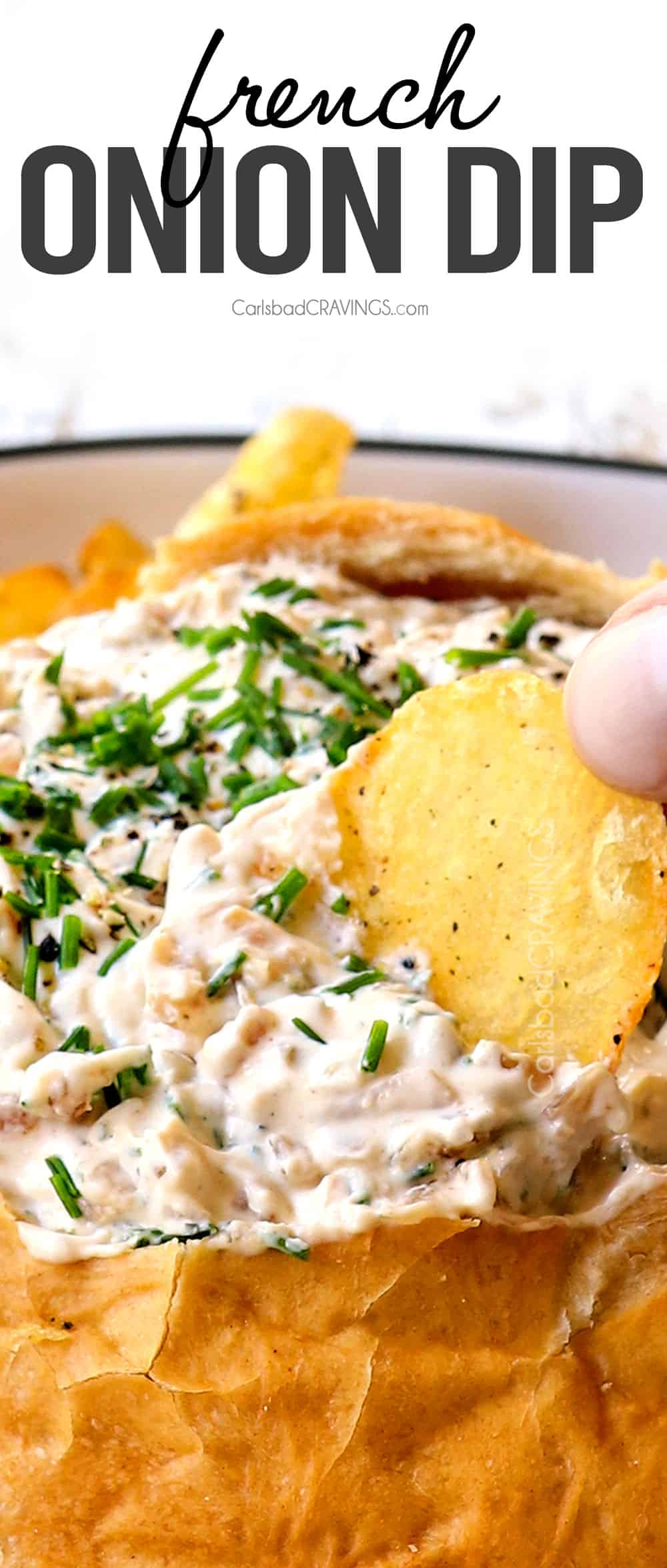 dipping into French Onion Dip with a potato chip