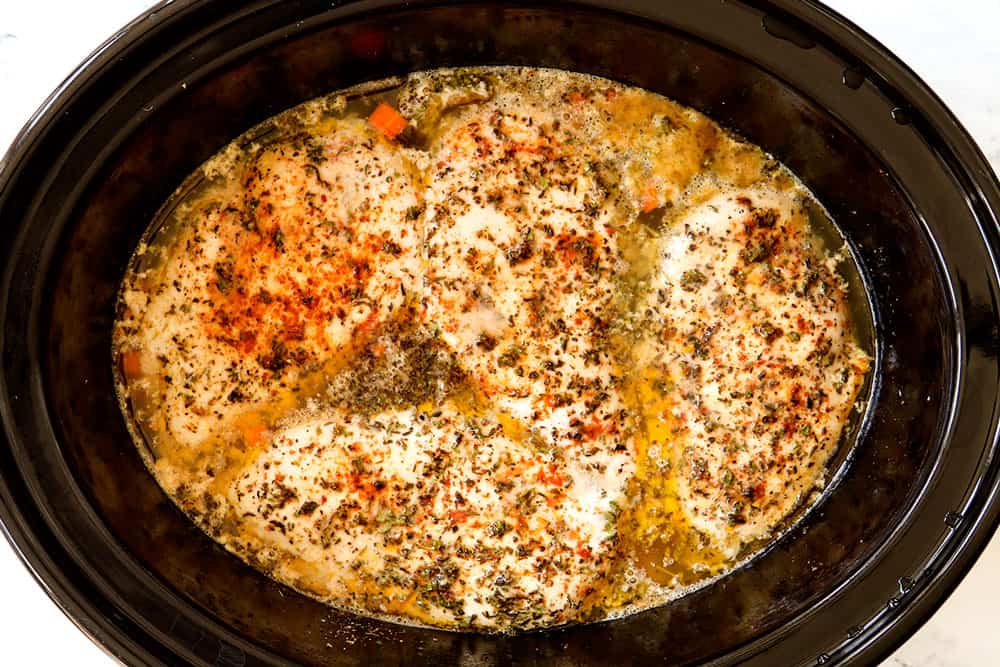 showing how to make Chicken and Rice Crockpot recipe by cooking chicken until 165 degrees F on top of the rice in the slow cooker