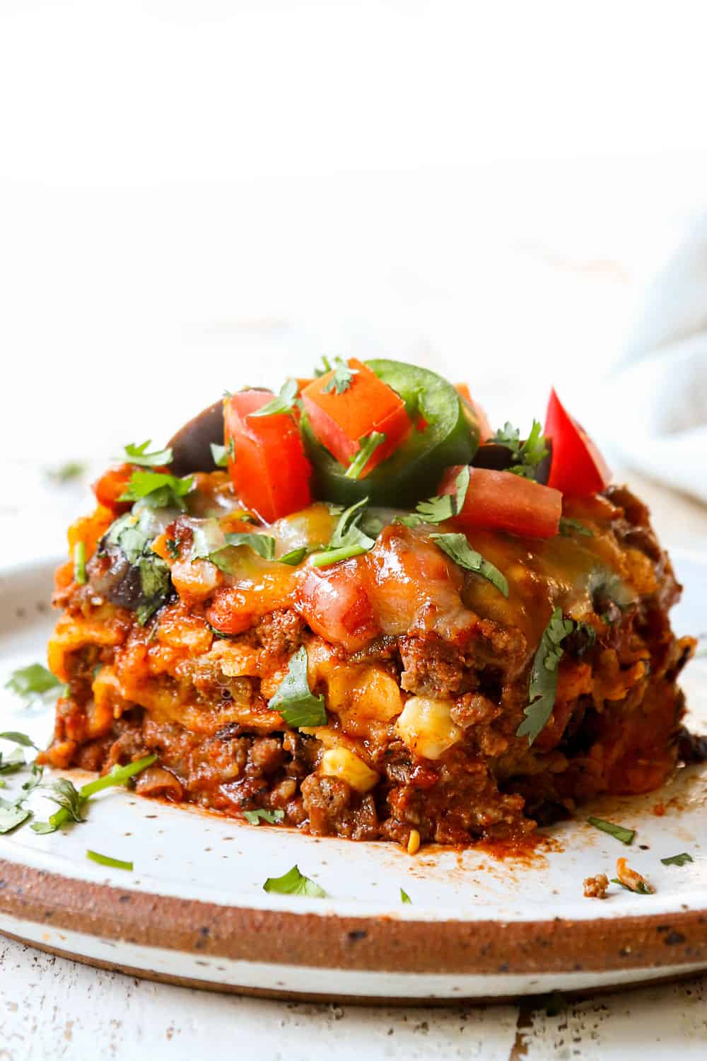 up close of a slice of beef enchilada casserole showing how cheesy it is