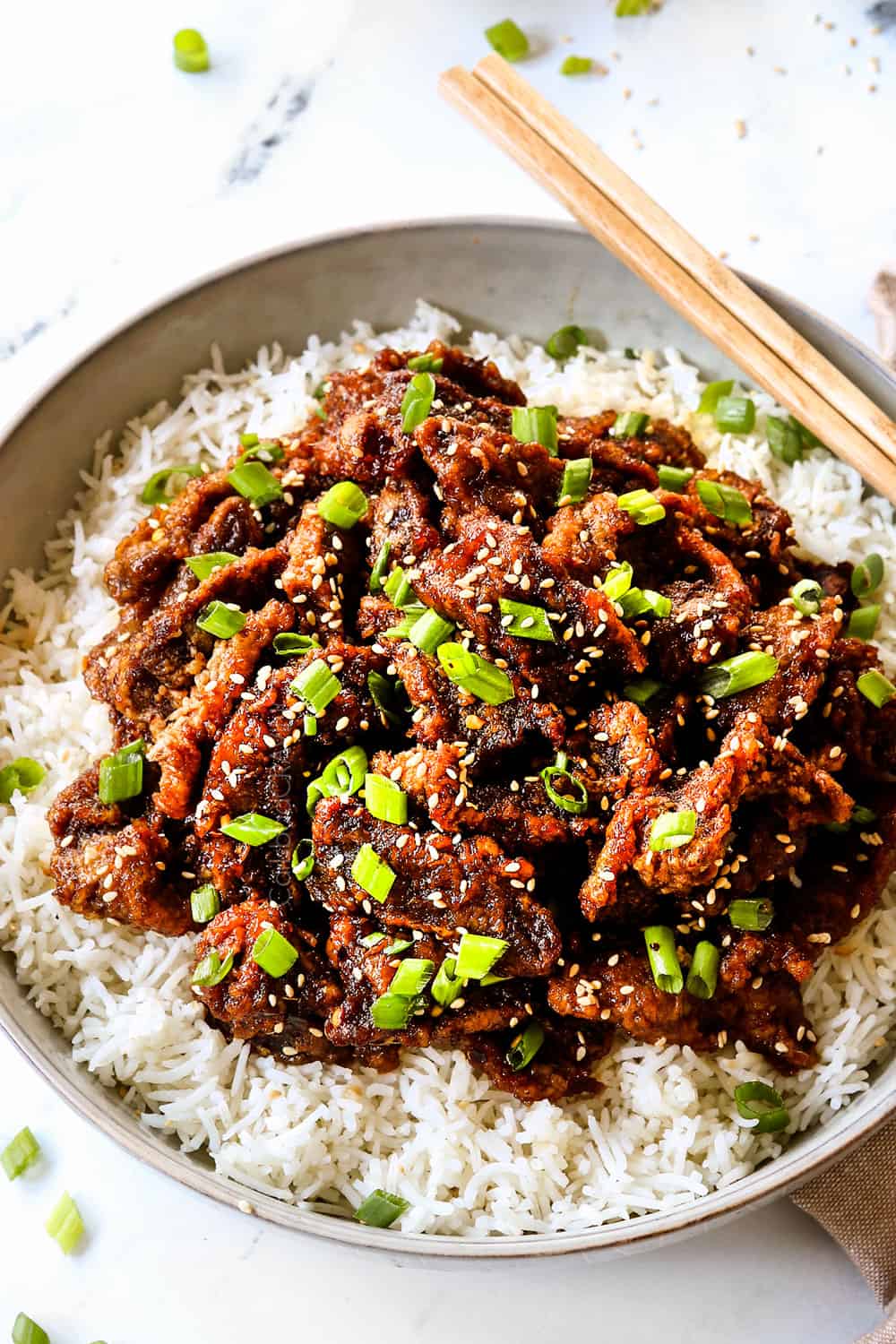 up close of Chinese ginger beef over rice showing how crispy the beef is