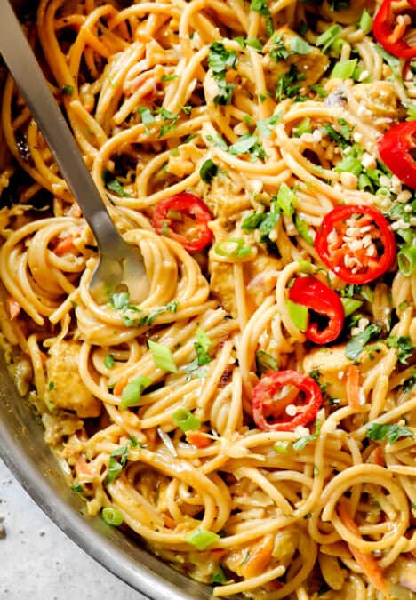 up close of Peanut Noodles in a skillet showing how creamy it is