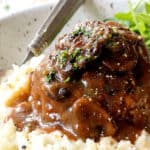 up close of homemade Salisbury Steak on mashed potatoes