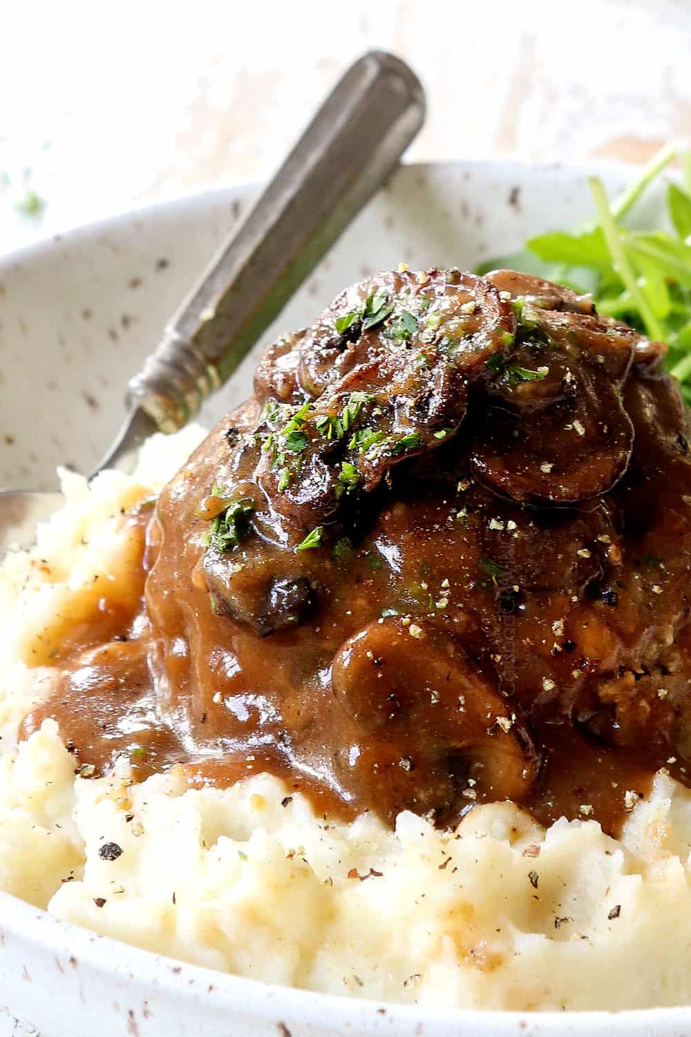 up close of homemade Salisbury Steak on mashed potatoes