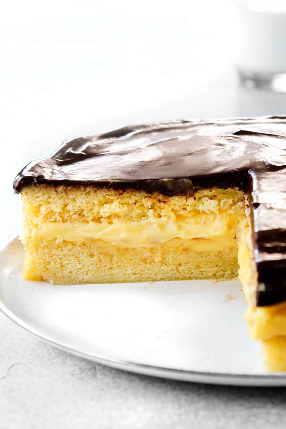 up close of Boston Cream Pie with a slice taken out of it
