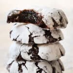 chocolate crinkle cookies stacked showing how thick they are