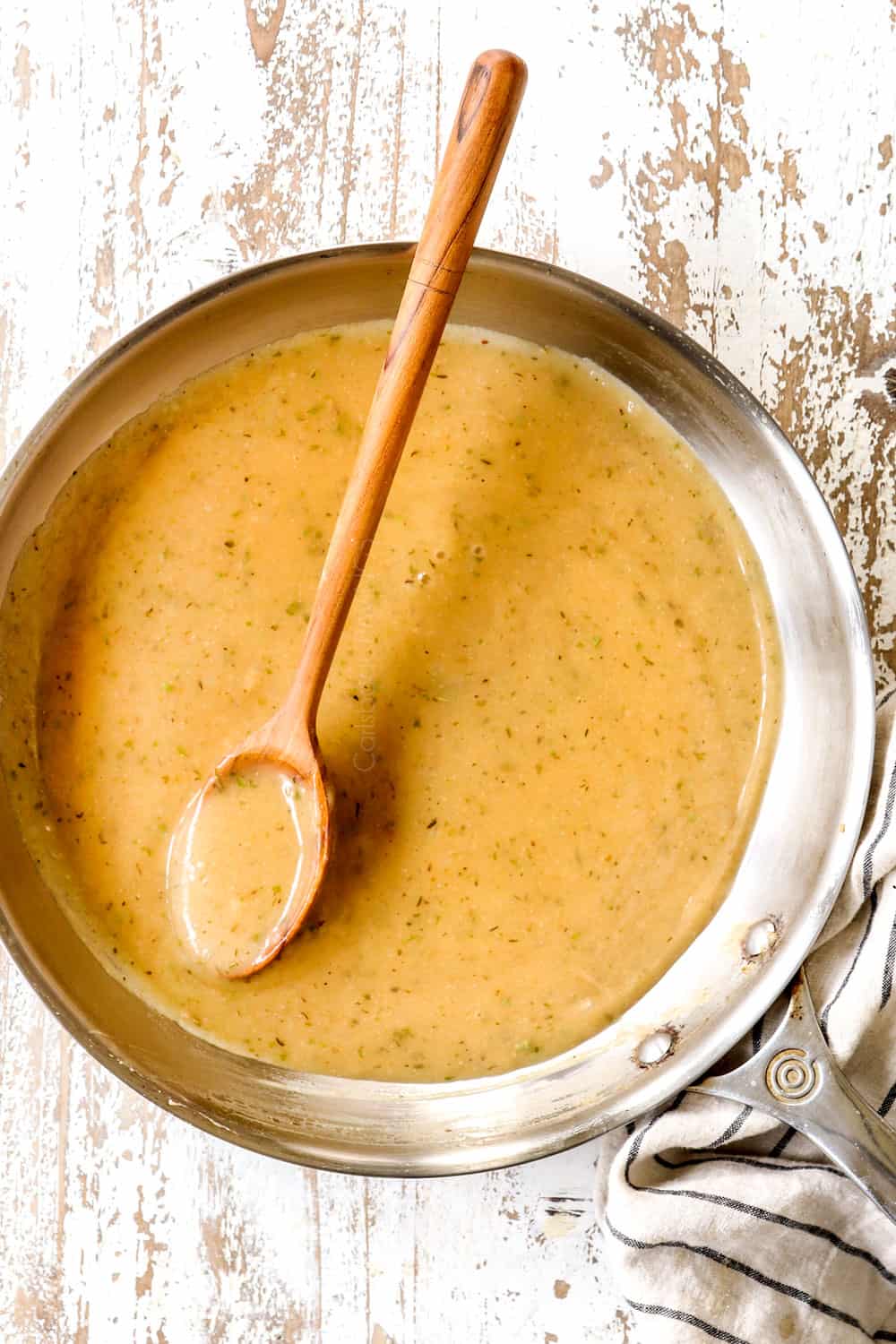 top view of how to make chicken gravy in a skillet by stirring until smooth