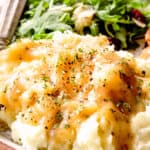 up close of chicken broth gravy over potatoes with herbs