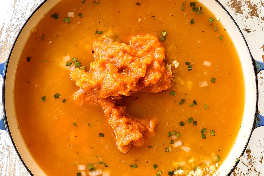 showing how to make pumpkin risotto by adding pumpkin and broth to the rice