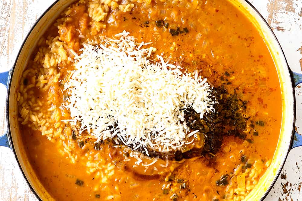 showing how to make pumpkin risotto by adding Parmesan to the risotto