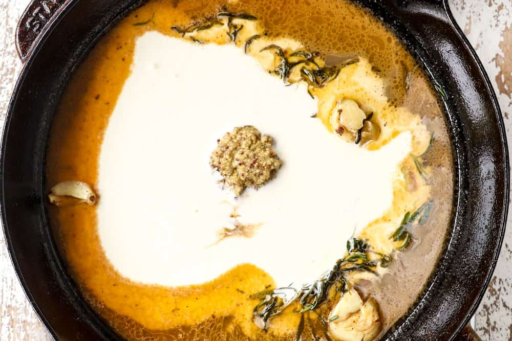 showing how to make filet mignon sauce by simmering Dijon mustard, garlic and heavy cream in a cast iron skillet