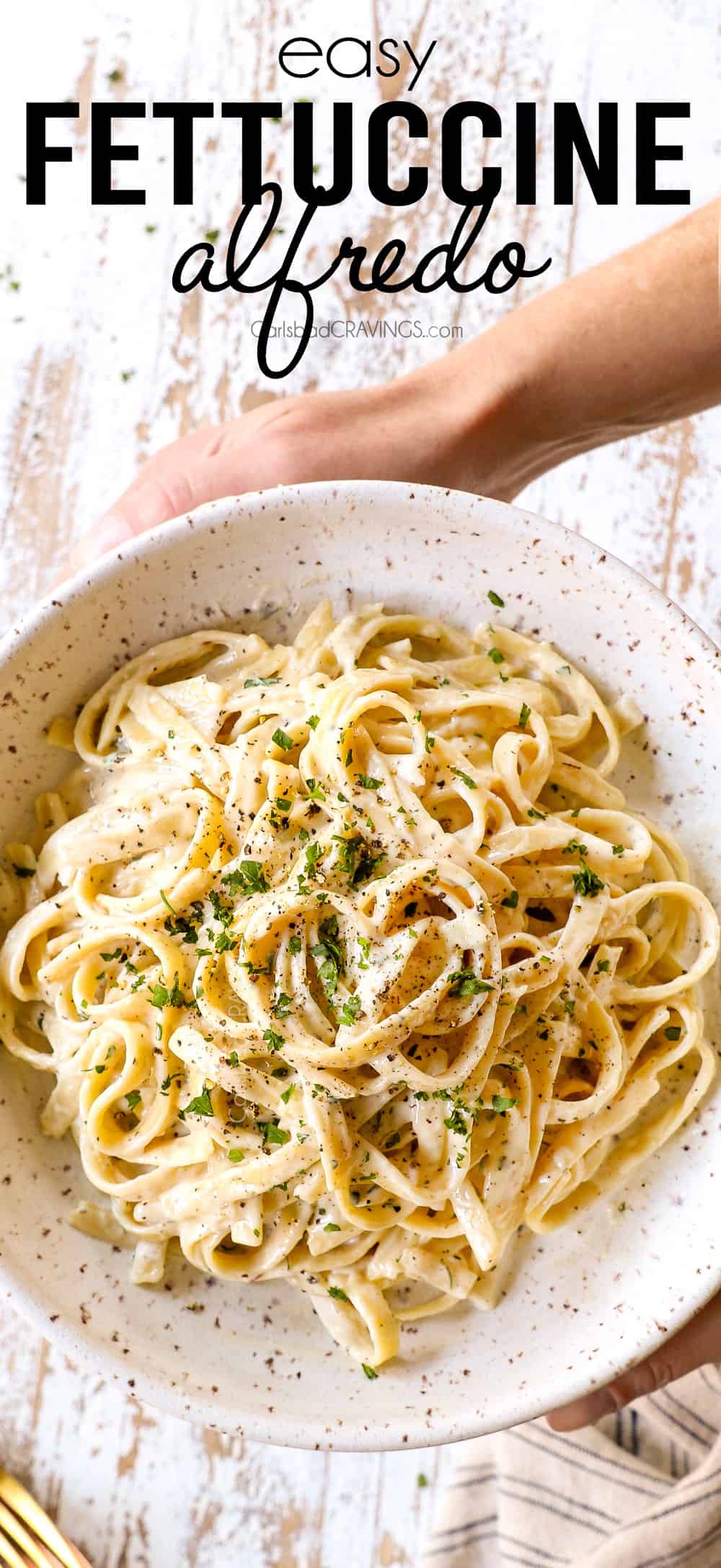 top view of fettuccine Alfredo in a bowl with freshly cracked pepper showing how creamy it is