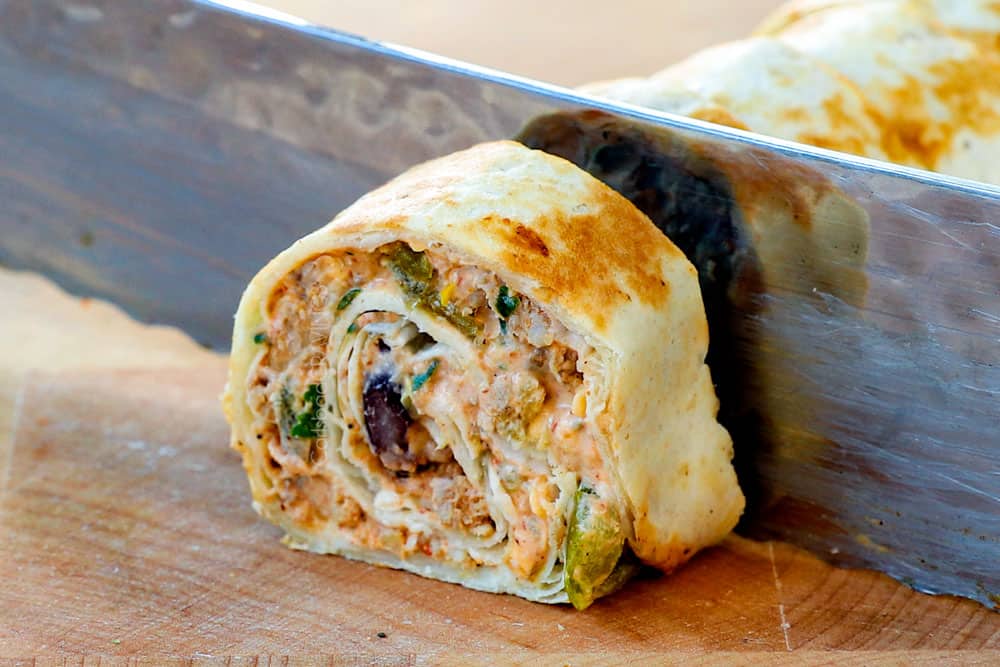 showing how to make pinwheels by slicing roll ups with a knife into 1-inch pieces