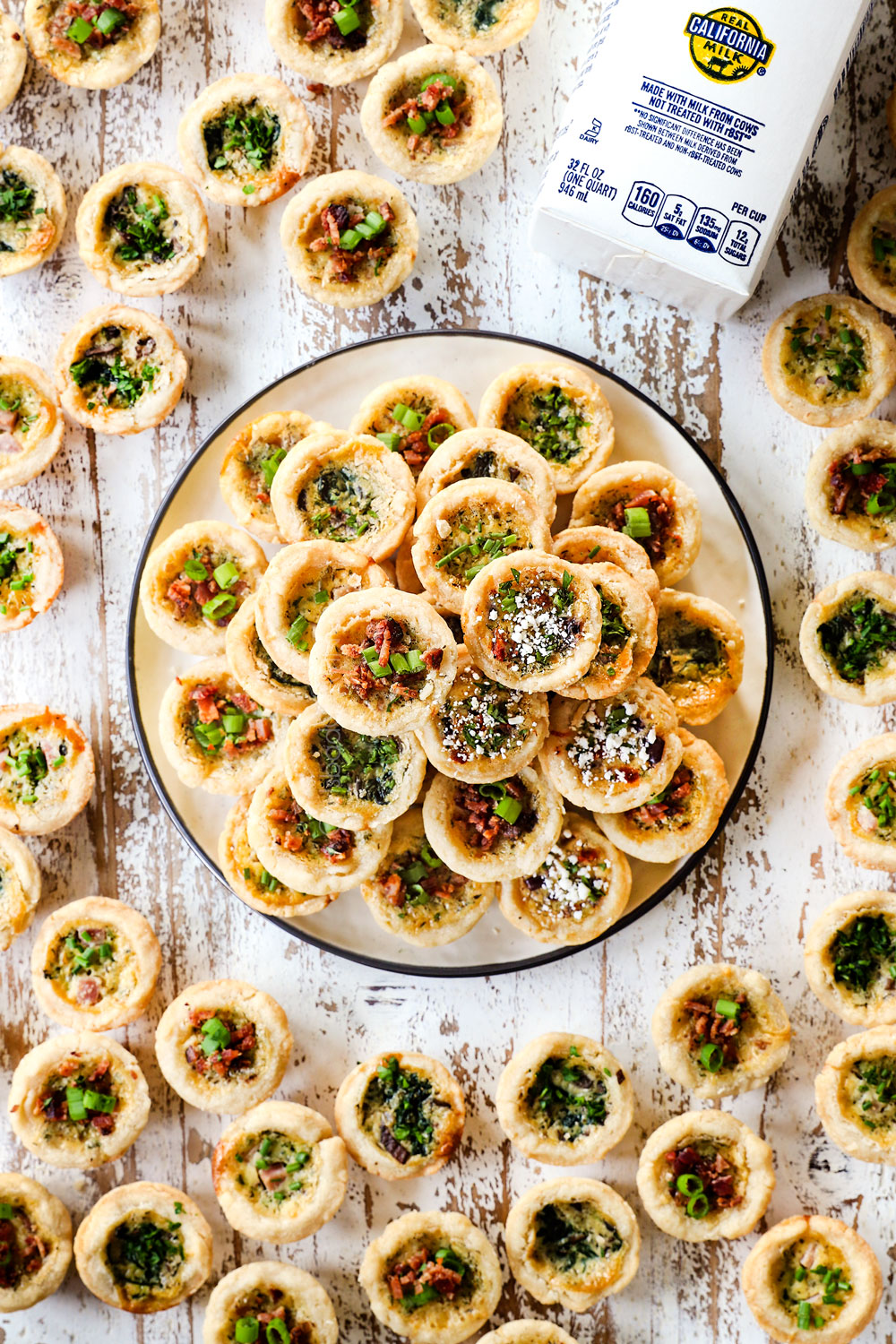 a plate of mini quiche garnished with fresh parsley and chives