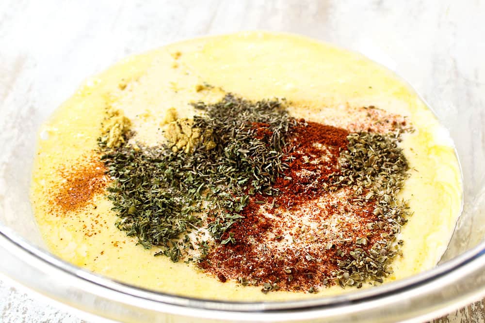 showing how to make mini quiche recipe by adding eggs, heavy cream and spices to a bowl and whisking together